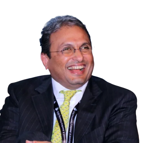 Russell Mehta laughing during a panel session, wearing a dark pinstriped suit and a conference lanyard.