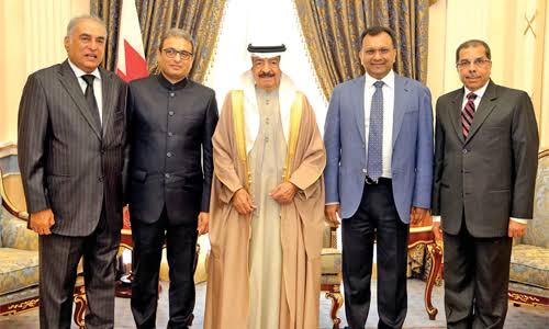 A five-person industry delegation photographed with a host dignitary during an official meeting overseas.